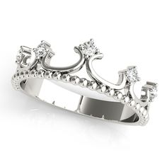 a princess's crown ring with diamonds on the sides and an intricate design in the middle