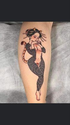 a woman's leg with a tattoo on it and a cat in the middle