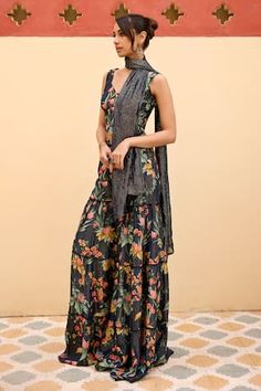 Navy blue blouse with all over floral garden prints. Paired with coordinating sharara and stole with beaded detailing. - Aza Fashions Floral Print Saree Dress For Summer, Unstitched Floral Sharara For Summer, Summer Floral Print Saree Dress, Fitted Sharara With Printed Motifs For Summer, Summer Fitted Sharara With Printed Motifs, Fitted Floral Print Palazzo Set For Summer, Summer Floral Print Saree Set, Bohemian Sleeveless Sets With Floral Print, Summer Floral Embroidery Sharara