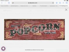 the word popcorn written in black and red on a wooden sign that reads, hot popcorn fresh