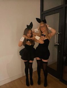 two women in bunny ears are posing for the camera