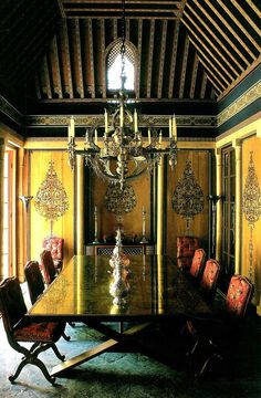 a dining room table with chairs and chandelier