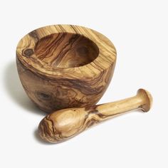 a wooden mortar and pestle on a white background