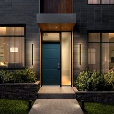 the front entrance to a modern home at night