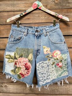 a pair of shorts with flowers and lace on them