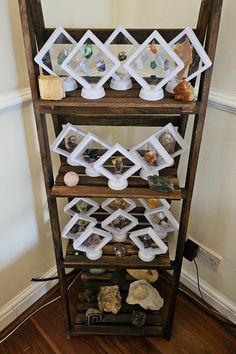 a wooden shelf filled with different types of rocks and stones on it's sides