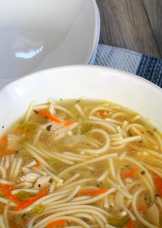 a white bowl filled with chicken noodle soup