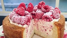 a cake with raspberry toppings on a plate