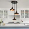 three lights hanging from the ceiling in a kitchen