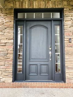 a black front door with two sidelights