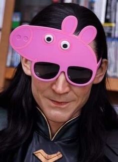 a woman wearing sunglasses with a pink object on her face and the caption says, don't look at me