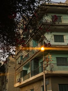 an apartment building with balconies on the second floor