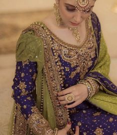 a woman in a blue and green bridal outfit