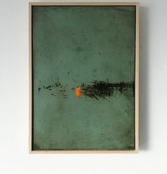 an orange piece is in the middle of a green painting on a white wall above a wooden frame