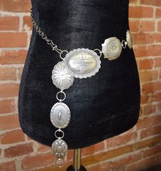 Two pieces of Jewelry in one!You will love the versatility of this sterling silver concho necklace that can also be worn as a concho belt! Additional Information: PLU: ORR-Concho-Chain-Neck Brand: VICKI ORR DESIGNS Vintage Silver Adjustable Chain Belt, Adjustable Silver Vintage Chain Belt, Elegant Concho Jewelry For Festival, Vintage Adjustable Chain Jewelry, Adjustable Vintage Chain Jewelry, Adjustable Vintage Style Chain Jewelry, Silver Lariat Jewelry, Silver Concho Metal Jewelry, Vintage Concho Lariat Necklace