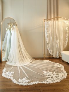 a wedding dress and veil are on display in the bridal room at a wedding venue