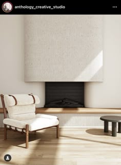 a white chair sitting in front of a fireplace