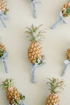 the pineapples are tied with blue ribbon and placed on top of each other