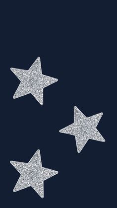 three silver glitter stars on a black background