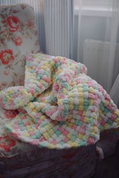 a pile of blankets sitting on top of a chair