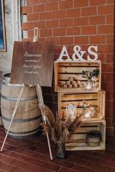 a wooden crate sitting on top of a brick floor next to a sign