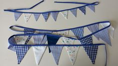 three blue and white buntings hanging on a wall