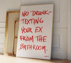 there is a sign that says no drunk texting your ex from the bath room