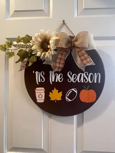 a door hanger that says it's the season with fall decorations