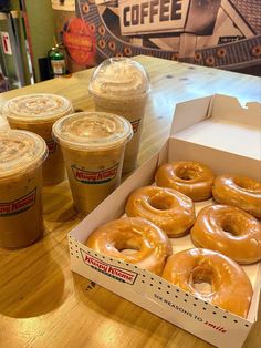 coffee and doughnuts are on the table at krispy kreme's