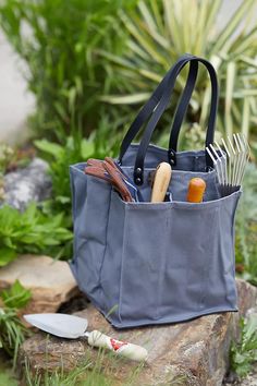 Perfect for the farmers' market, grocery store, a picnic, outdoor concert, or even as a baby bag, this tote is effortlessly cool, super durable, and incredibly practical. Featuring six long pockets large enough to hold a dozen eggs, a baguette, bottle of wine, jar of olive oil, bushel of kale, and a bunch of carrots. There's an exterior strap for floral bouquets that allows water to drip on the outside of the bag while the long faux leather straps ensure a comfortable fit. Picnic Outdoor, Market Tote Bag, Outdoor Concert, Silent Auction, Hand Poured Candle, Market Tote, Garden Inspired, Garden Tote, Floral Bouquets