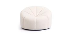 a small white ottoman sitting on top of a white floor next to a black base