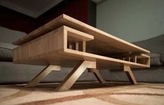 a wooden table sitting on top of a carpeted floor