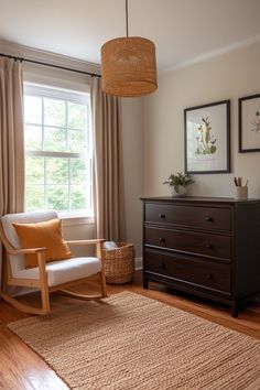 a living room with a chair, dresser and window