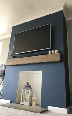 a flat screen tv mounted above a fireplace