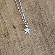 Solid .925 Sterling Silver Star minimalist Necklace. This adorable TINY star charm necklace features a simple, flat star that measures 11mm. Makes a great gift for the stargazer or superstar in your life. Tiny star Charm comes attached to a well-made, 0.8mm Sterling Silver Cable or Box chain in the length of your choice (you choose the style and the length at checkout) USA-made, stamped 925. Comes in a small gift box ready for gift-giving Minimalist Star Charm Pendant Necklace, Sterling Silver Starfish Charm Necklace, Sterling Silver Necklace With Starfish Charm, Minimalist Star Necklace For Everyday, Silver Star Print Necklace, Silver Necklace With Star Print For Gift, Silver Star Print Necklace Perfect For Gift, Silver Star Print Necklace For Gift, Silver Star Charm Necklace