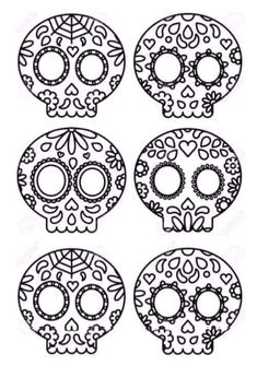 four sugar skulls with different designs on them