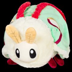 a white stuffed animal with red and green ears