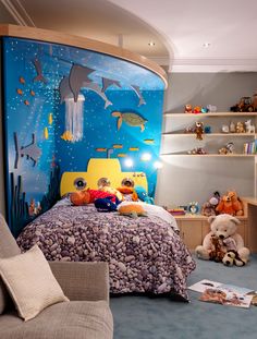 a child's bedroom decorated in blue, yellow and orange with an underwater theme