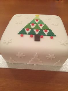 a white cake with a christmas tree on it