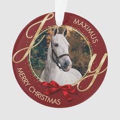 a merry christmas ornament with a white horse