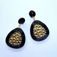 Invest in the allure of our Gold and Black African-Style Earrings and embrace the spirit of African heritage with every wear. Make a statement that transcends fashion and embodies the timeless beauty of cultural fusion. These earrings are more than accessories; they are a celebration of craftsmanship, tradition, and your unique sense of style. Add a touch of African elegance to your jewellery collection and let these earrings become a symbol of your appreciation for artistry and cultural diversi Handmade Black Dangle Clip-on Earrings, Black Brass Hoop Earrings As Gift, Black Dangle Plug Earrings As Gift, Black Dangle Plug Earrings For Gift, Single Black Brass Earring, Handmade Black Brass Earrings, Handmade Black Clip-on Earrings For Gift, Nickel-free Black Brass Earrings, Black Clip-on Earrings As Gift