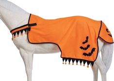 a white horse wearing an orange cape with bats on it