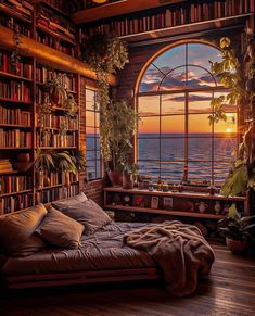 a bed sitting in front of a window next to a book shelf filled with books