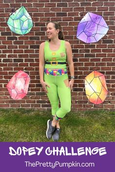 a woman standing in front of a brick wall with colorful paper lanterns hanging from it