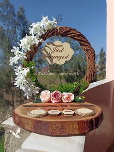 a wooden table topped with flowers and cookies