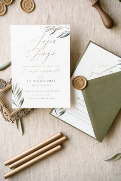 the wedding stationery is laid out on top of each other, including a wax stamp