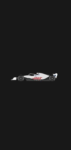 a racing car in the dark on a black background with no image to describe it