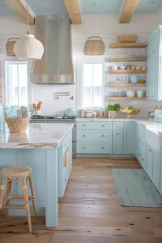 a kitchen with blue cabinets and white counter tops, wooden floors and open shelving