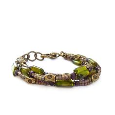 Triple-strand bohemian bracelet. I used Czech glass rectangle beads in an exceptional shade of olive green and added small metallic seed bead cubes that have a wonderful shimmer. Detailed bronze spacer beads compliment the colors and a chunky bronze lobster clasp ties it all together.  * Adjustable - 7 1/4 to 8" (18 to 20cm) long Your bracelet will arrive in a gift box.Browse more of my handmade bracelets here:http://etsy.me/1dvQHuzSHOP ENTRANCE:http://www.etsy.com/shop/RockStoneTreasuresThanks Bohemian Green Bracelet With Spacer Beads, Bohemian Multi-strand Bracelets With Large Beads, Bohemian Green Bracelets With Spacer Beads, Bohemian Jewelry With Large Rectangular Beads, Bohemian Double Strand Bracelet With Faceted Beads, Green Bohemian Multi-strand Beaded Bracelets, Bohemian Czech Glass Beads Bracelet, Bohemian Adjustable Rectangular Bracelets, Bohemian Adjustable Rectangular Bracelet