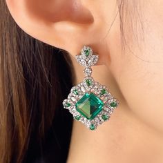 ✰ 2 shiny emerald shape green cz gemstones makes the drop earring with halo more sparkly and graceful  ✰ This delicate lab-created handmade gemstone dangle earrings is perfect for people who want to achieve a brilliant and splendid look ✰ This green earrings dangle not only suitable for formal occasions such as banquets, weddings, theme parties, but also for everyday wear ✰ This dangle earrings wedding is a very special gift for birthday, Mother's Day, Valentine's Day and more  ✰ Comes with an exquisite gift box We also offer the necklace and ring from the same collection: https://www.etsy.com/listing/1237643461/green-emerald-cut-necklace-green https://www.etsy.com/listing/1217077278/green-emerald-cut-ring-vivid-green Materials: Environmentally-friendly copper Needle Materials: Silver Quan Green Diamond Earrings For Formal Occasions, Green Diamond Earrings For Evening, Green Diamond Drop Earrings, Green Cubic Zirconia Diamond Drop Earrings, Emerald Drop Diamond Earrings For Wedding, Green Diamond Drop Bridal Earrings, Green Diamond Earrings For Parties, Green Diamond Drop Earrings For Bridal, Green Diamond Party Earrings